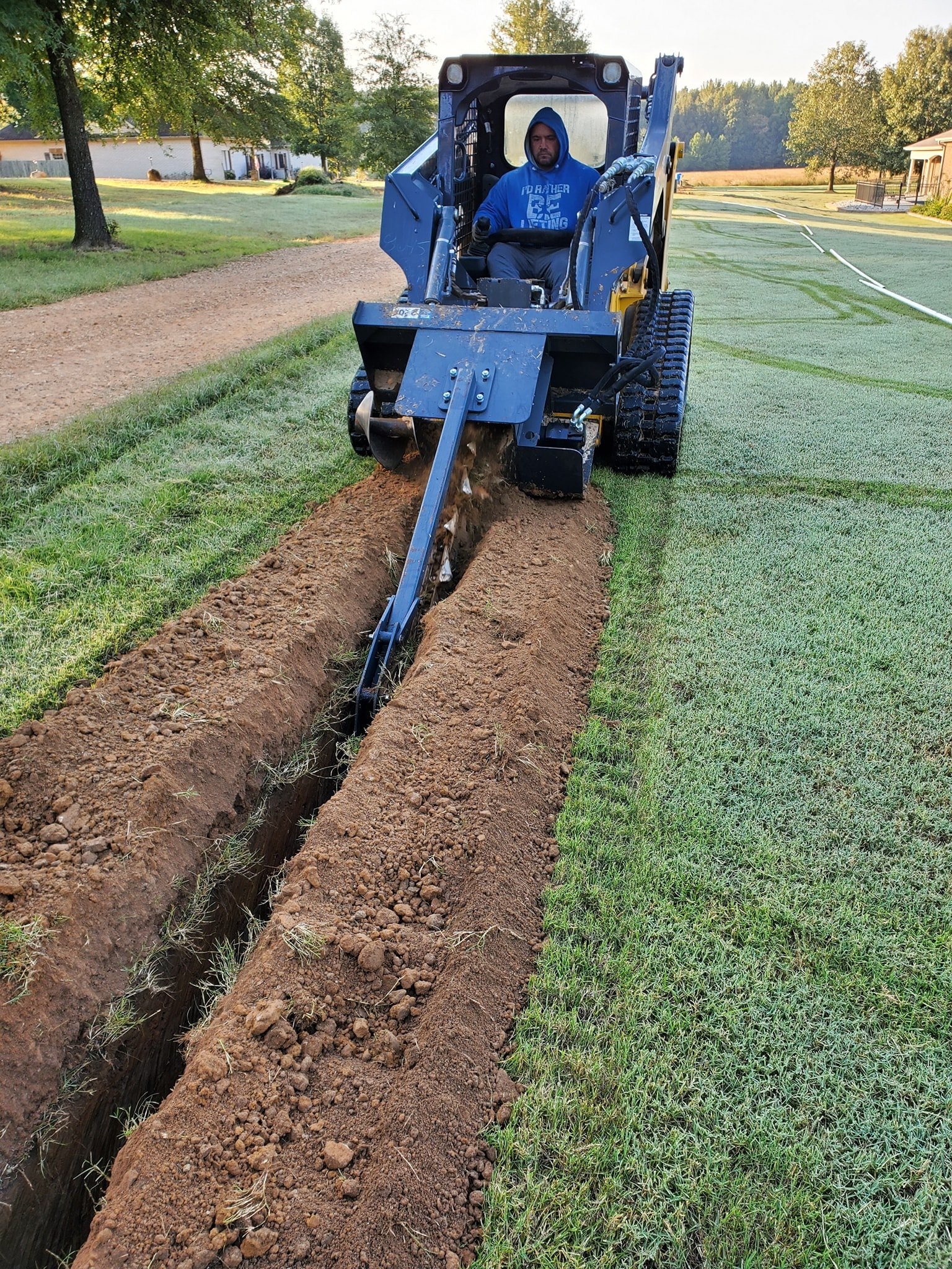 crew digging trench for drainage pipe