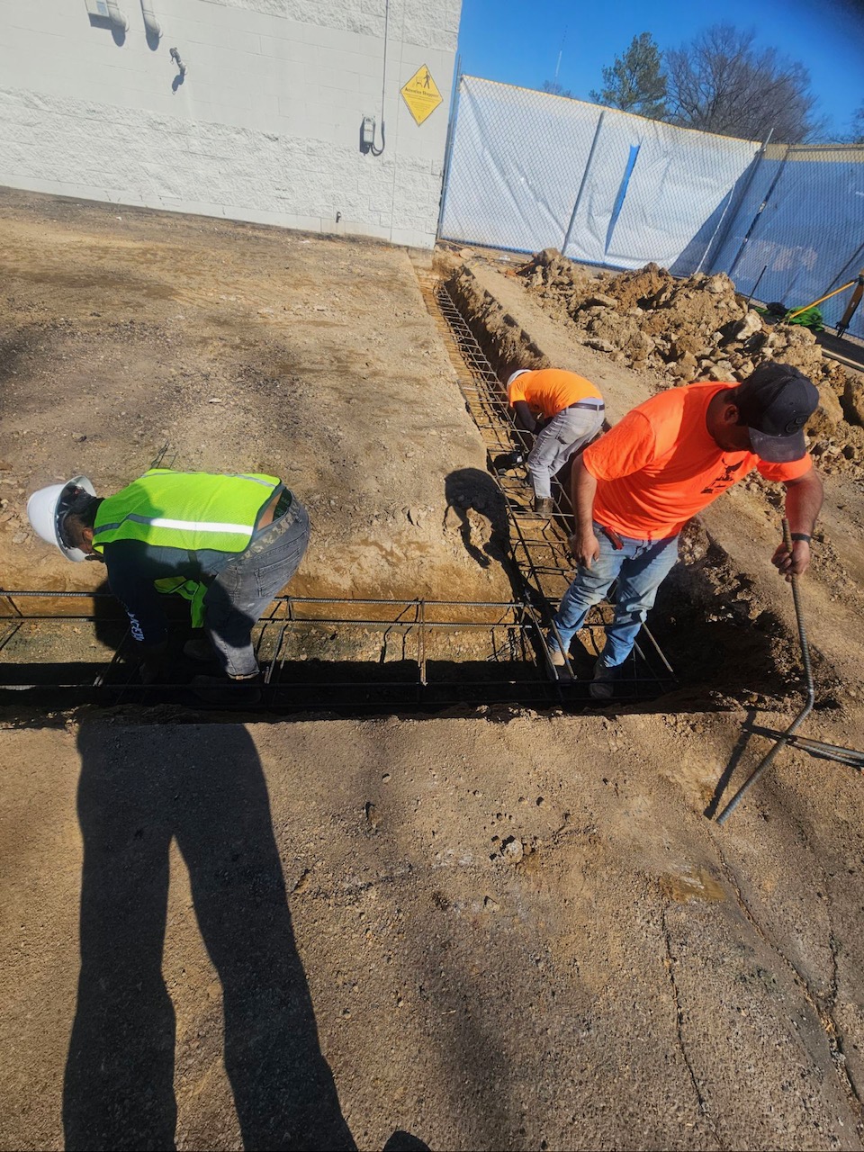 crew laying foundation for new construction