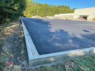 newly paved concrete parking lot